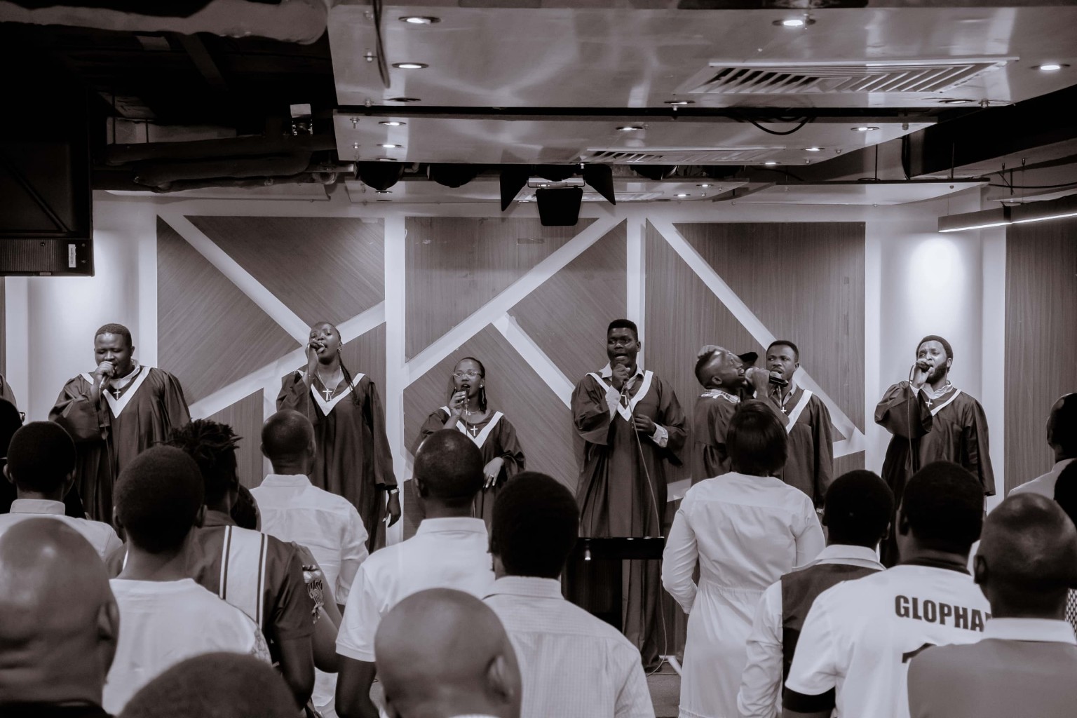 Black and white photograph of the church choir singing before the congregation