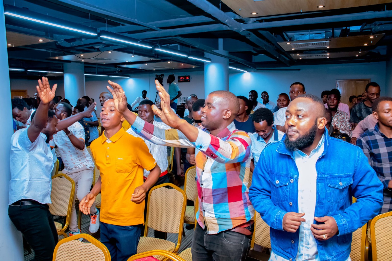 Members of the congregation worshipping with hands raised